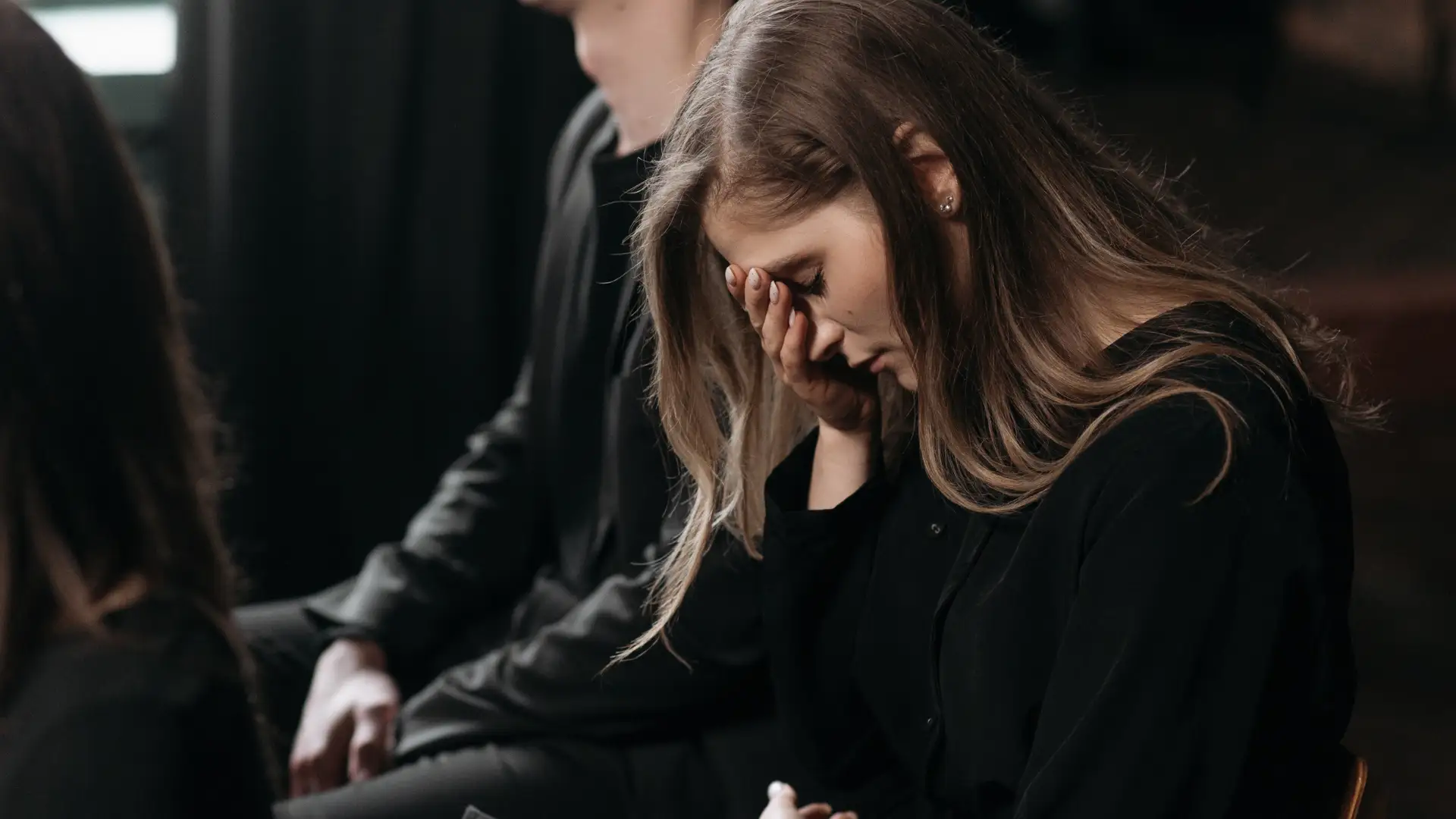 Grieving woman at a funeral service.